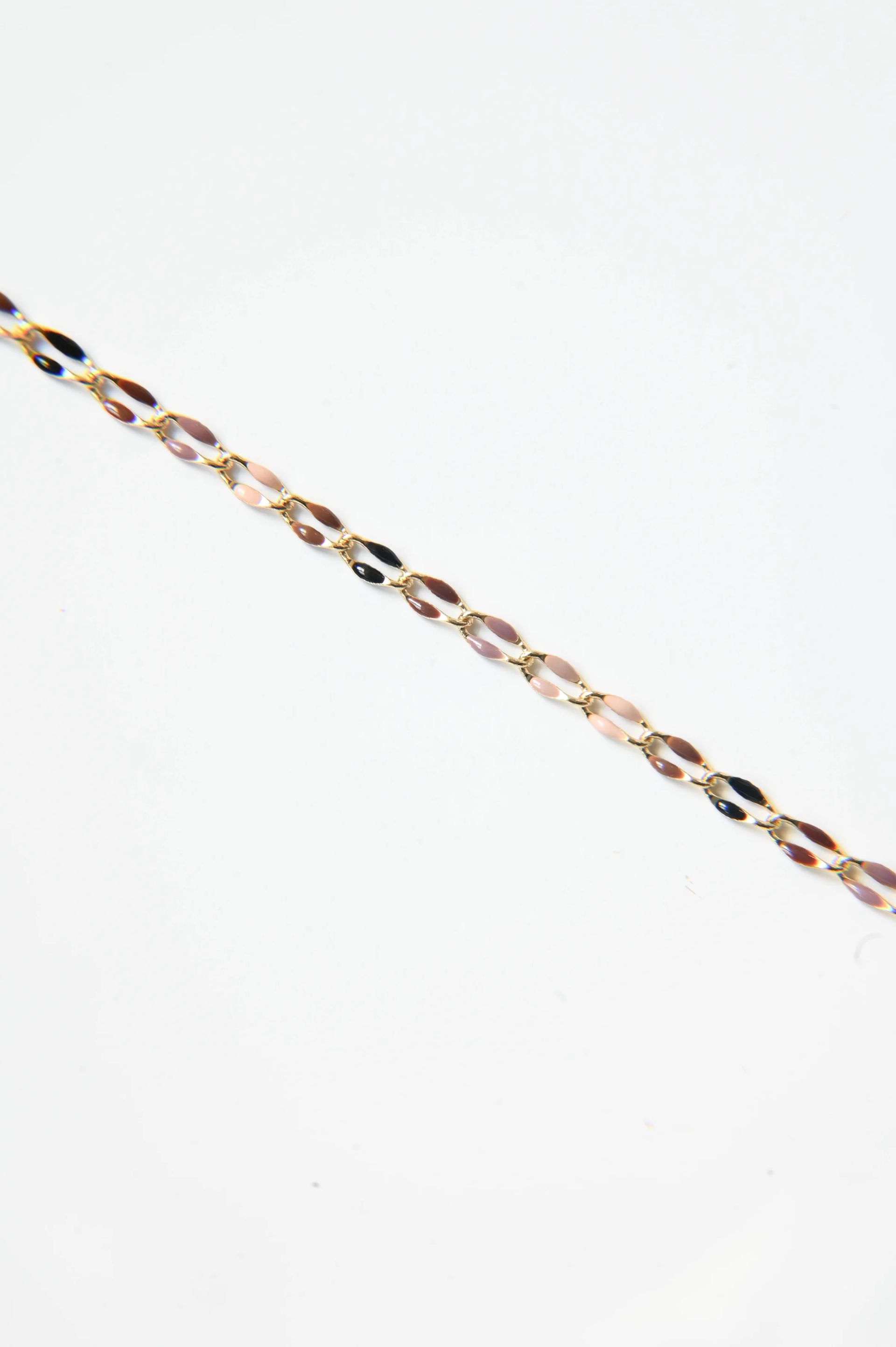 A close up of a chain on a white background.