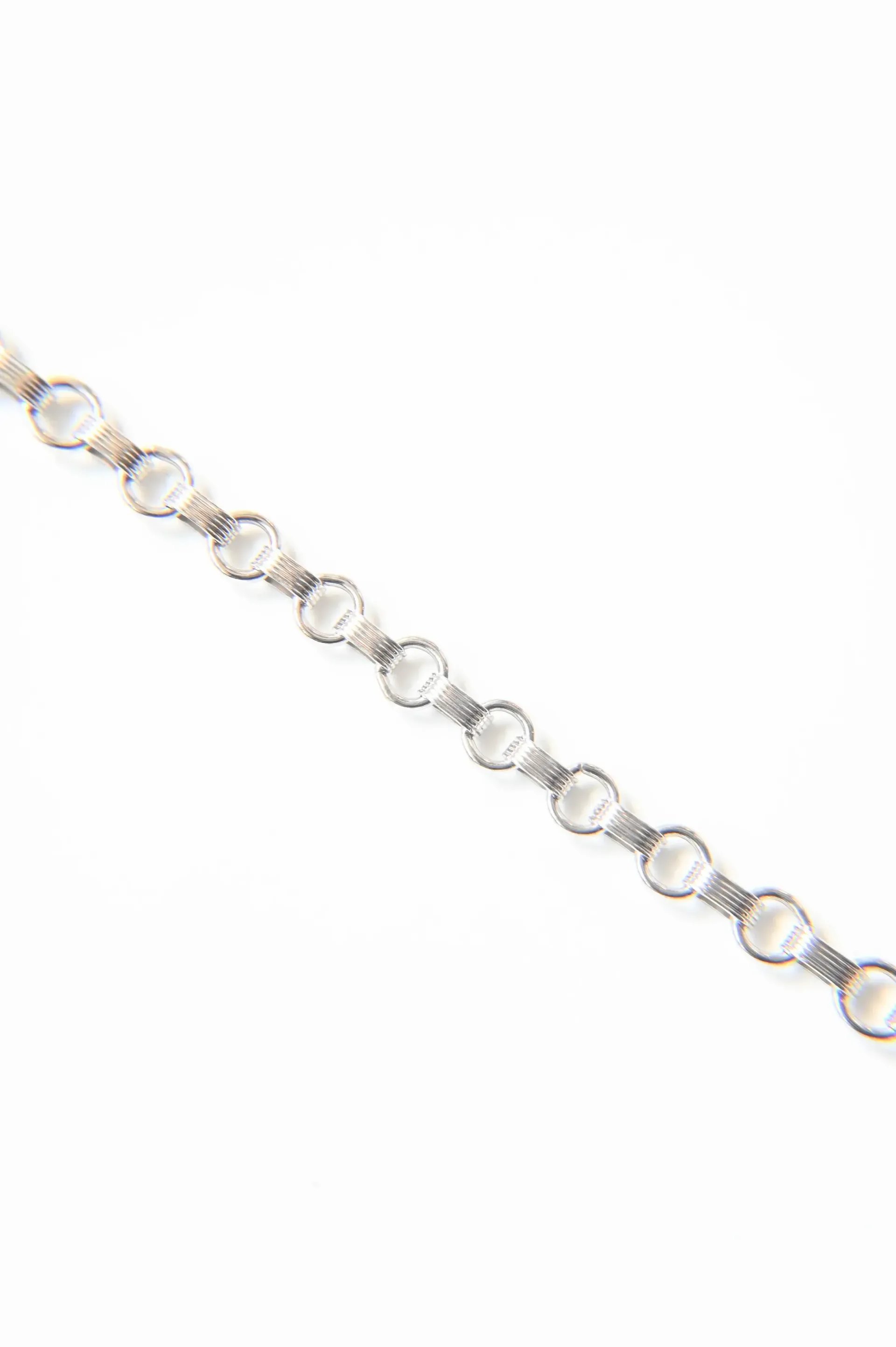A silver bracelet with pearls and diamonds on a white background.
