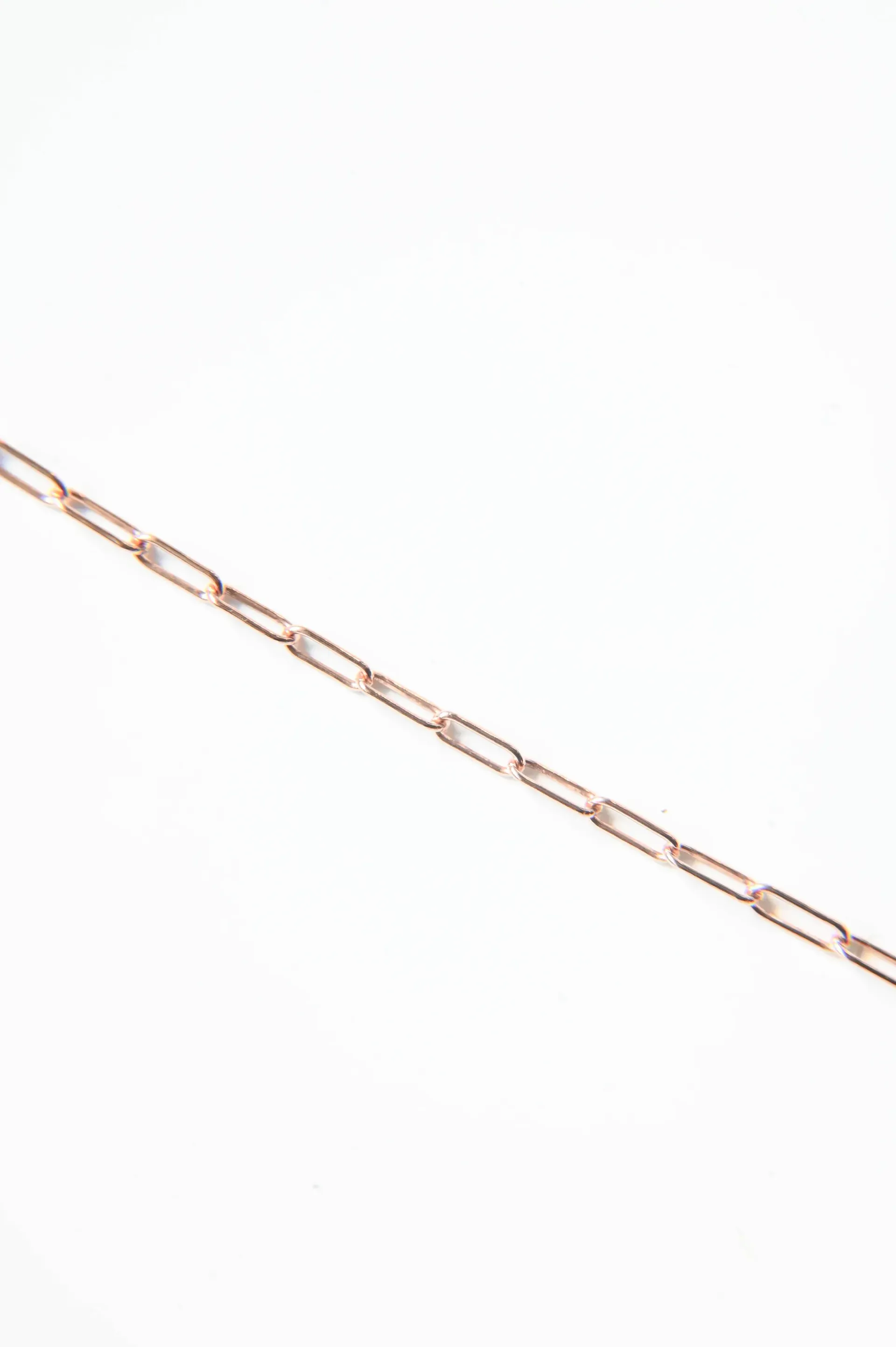 A close up of a chain on a white background.