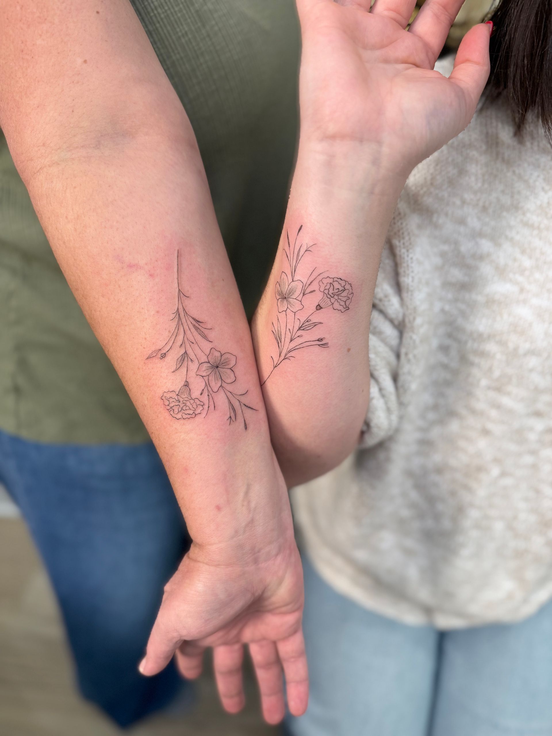 A close up of a person getting a tattoo on their leg.