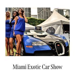 Women in blue dresses pose next to a blue and black Bugatti Veyron at a Miami Exotic Car Show.