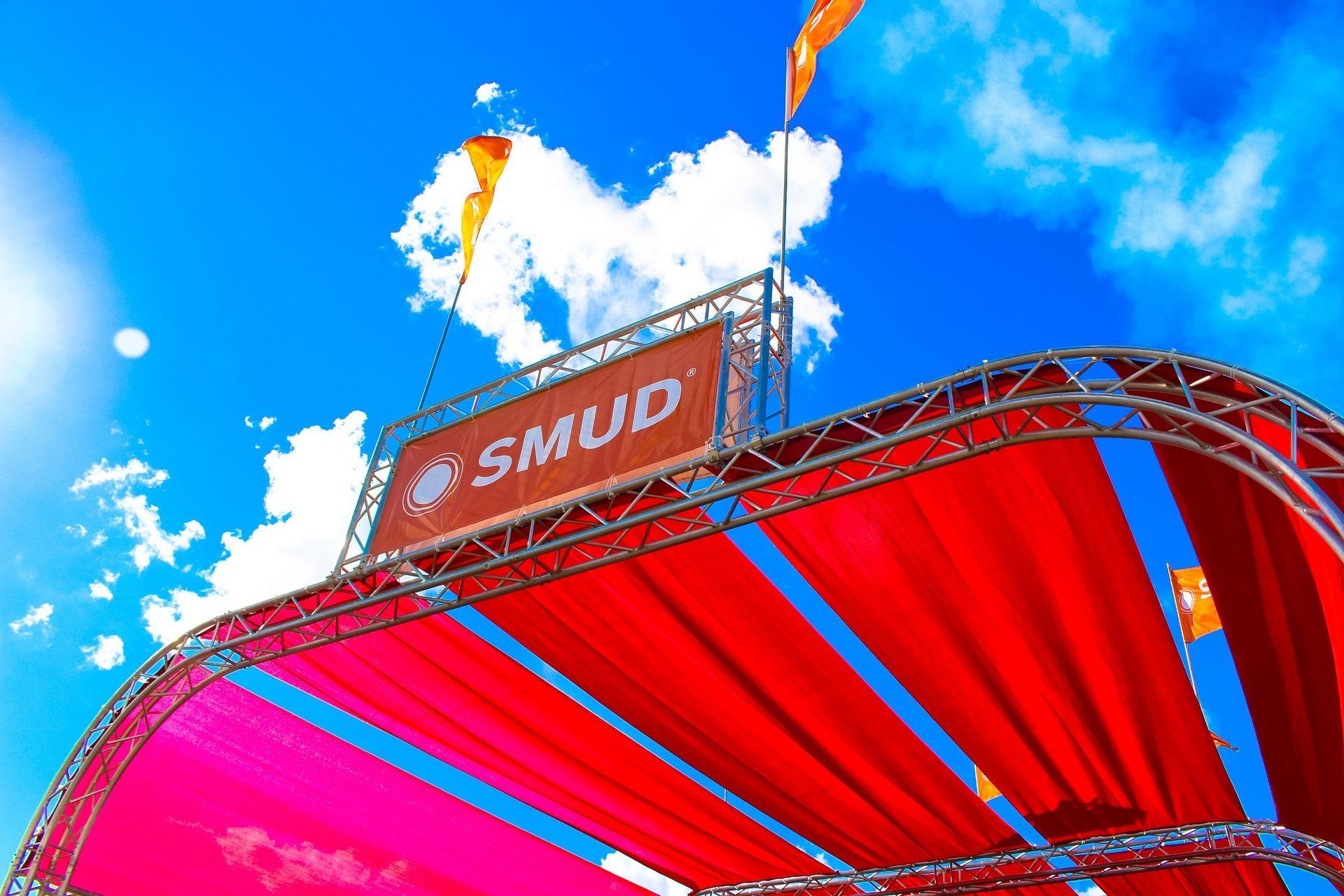 A red tent with a sign that says smud on it