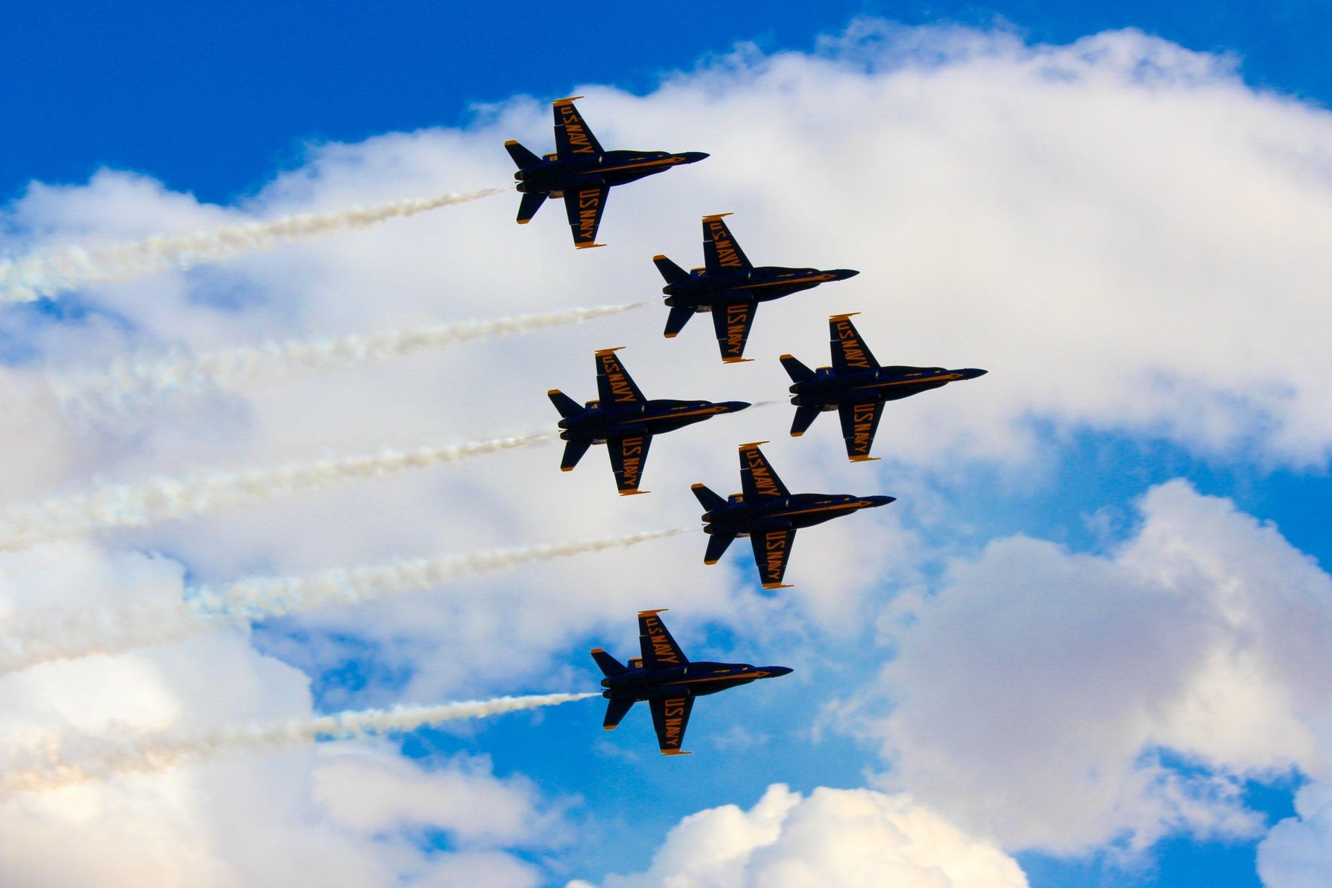 A group of fighter jets are flying in formation in the sky.