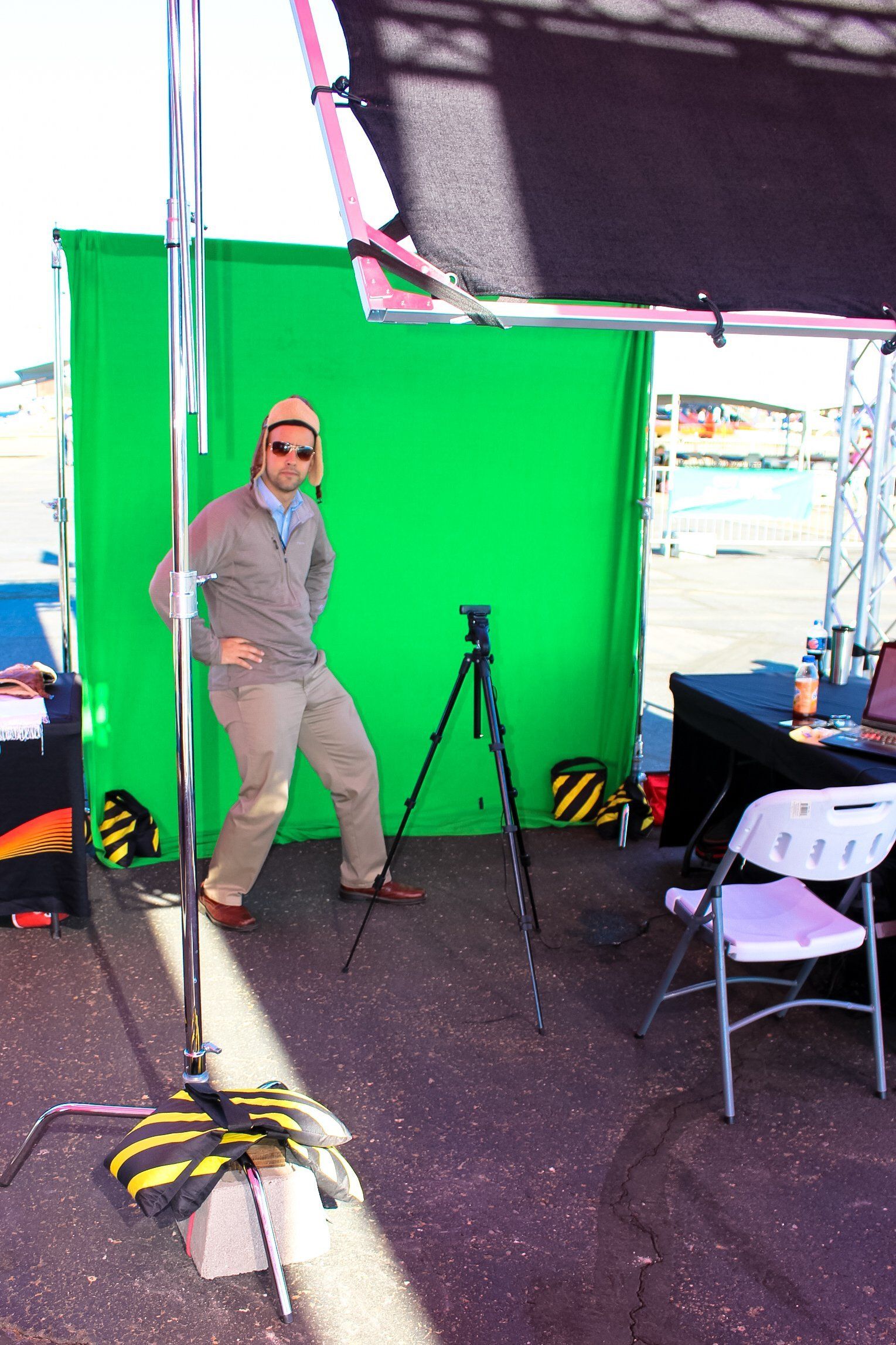A man standing in front of a green screen