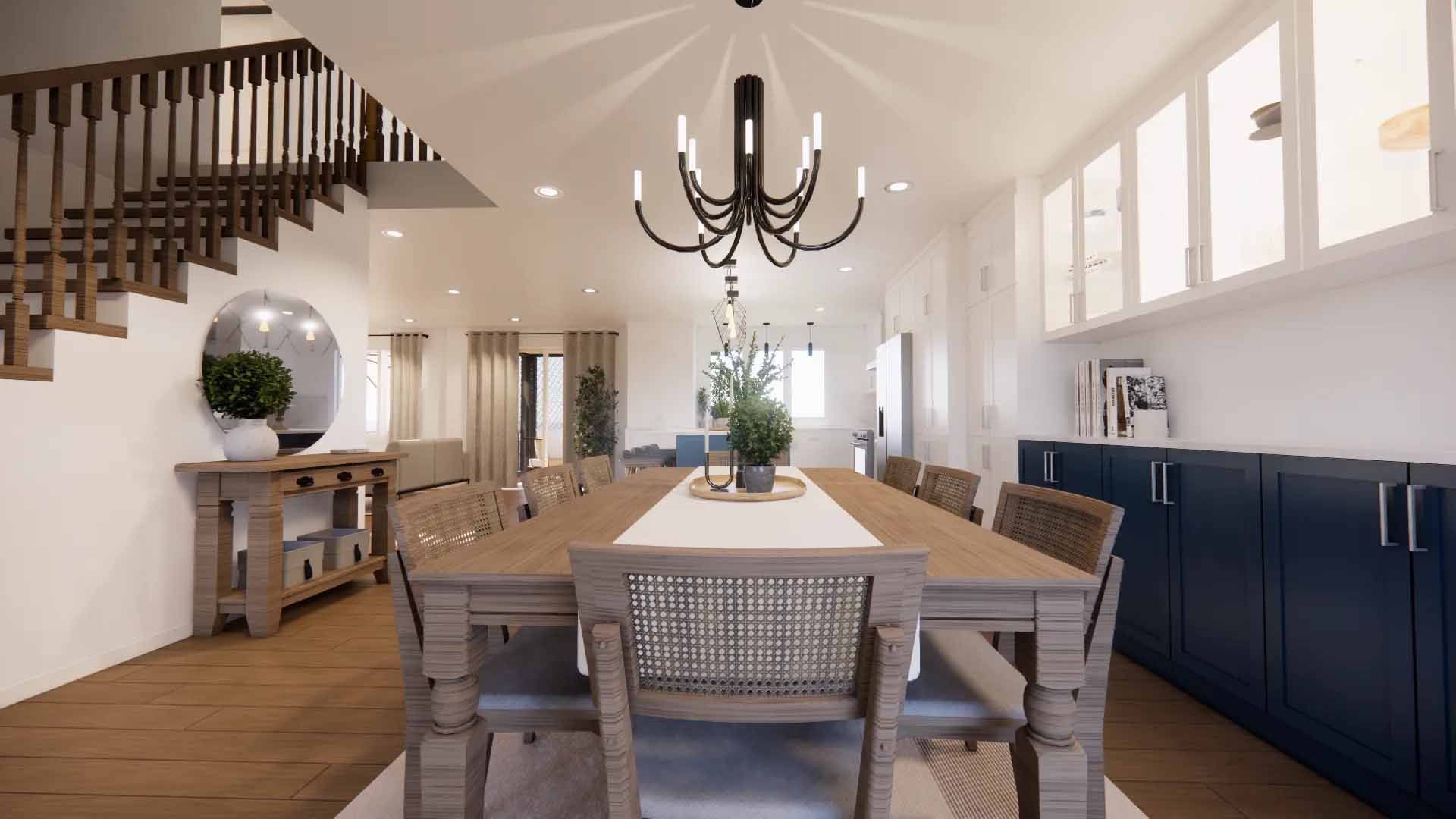 Salle à manger avec une longue table en bois, un lustre et un escalier.