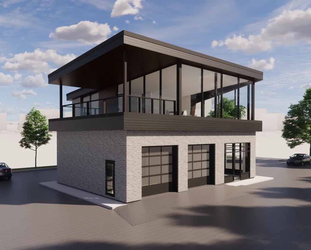 Bâtiment moderne de deux étages avec portes de garage, murs vitrés et toit sombre ; ciel couvert.