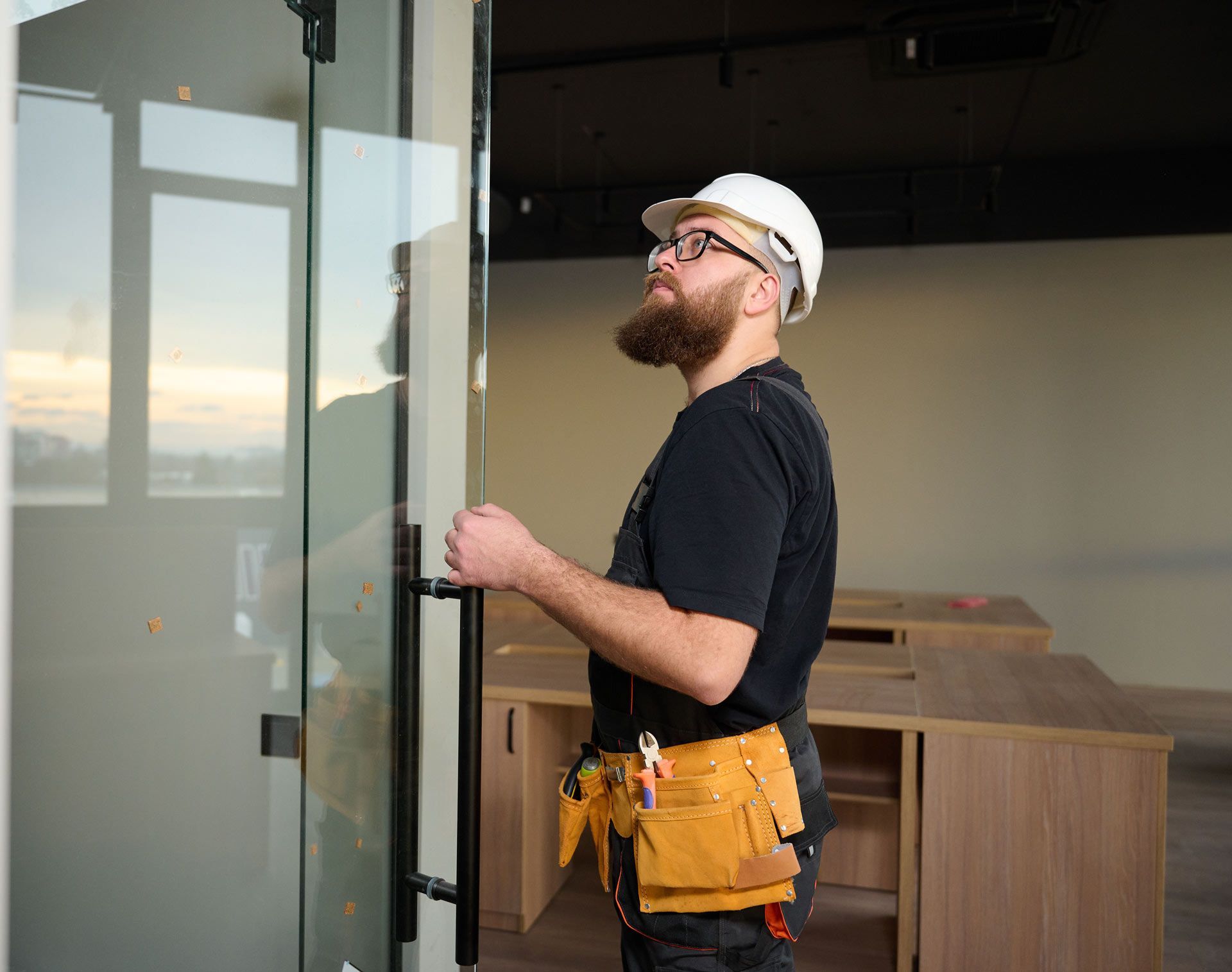 Construction worker installing door in a new house construction.