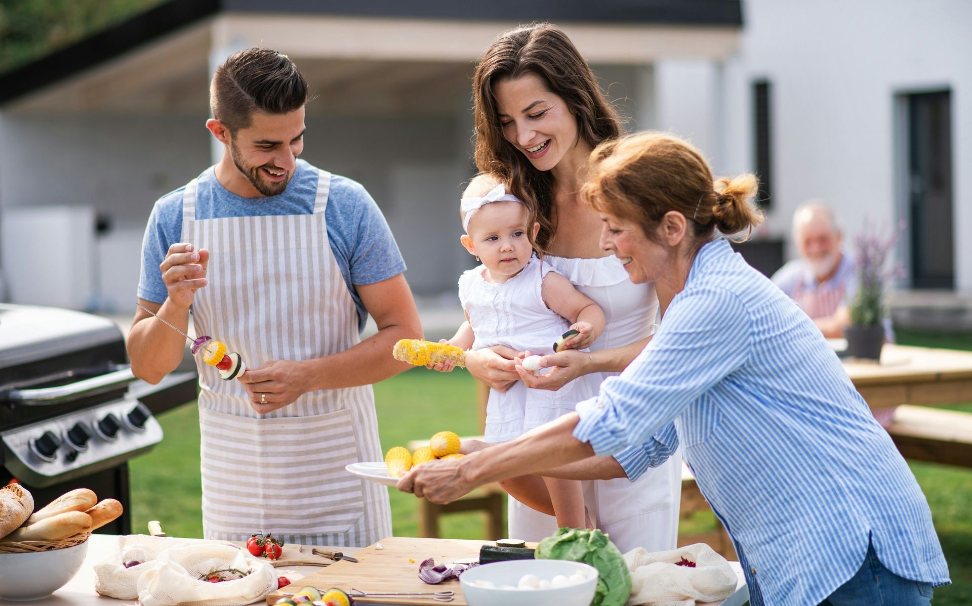 A family is having a barbecue in their backyard.
