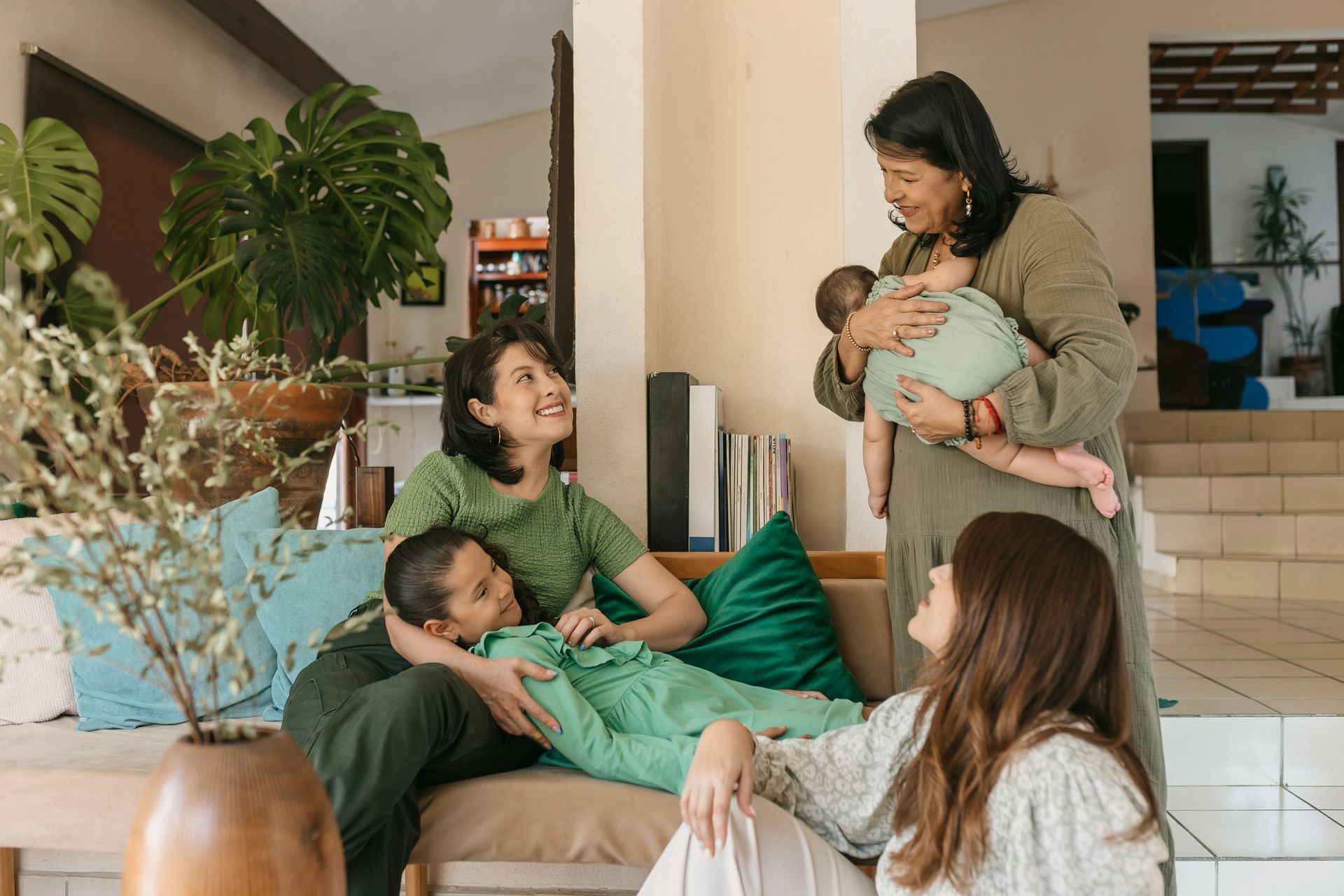 A group of people are sitting on a couch in a living room.