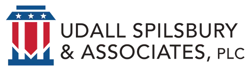 The logo for udall spilsbury & associates , plc