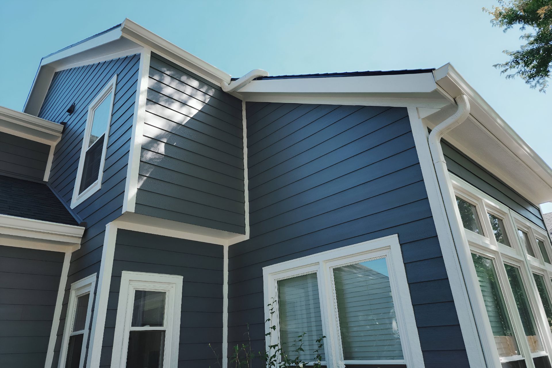 A house with a blue siding and white trim — Overland Park, KS — Johnson County Solutions
