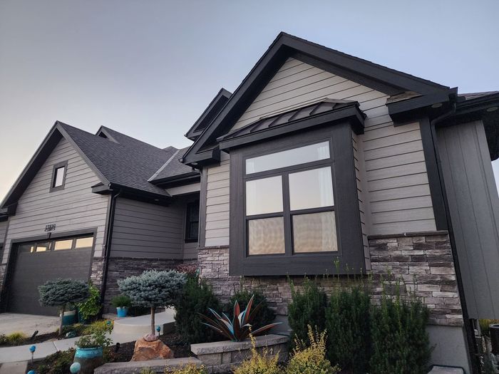 A large house with a lot of windows and a garage — Overland Park, KS — Johnson County Solutions