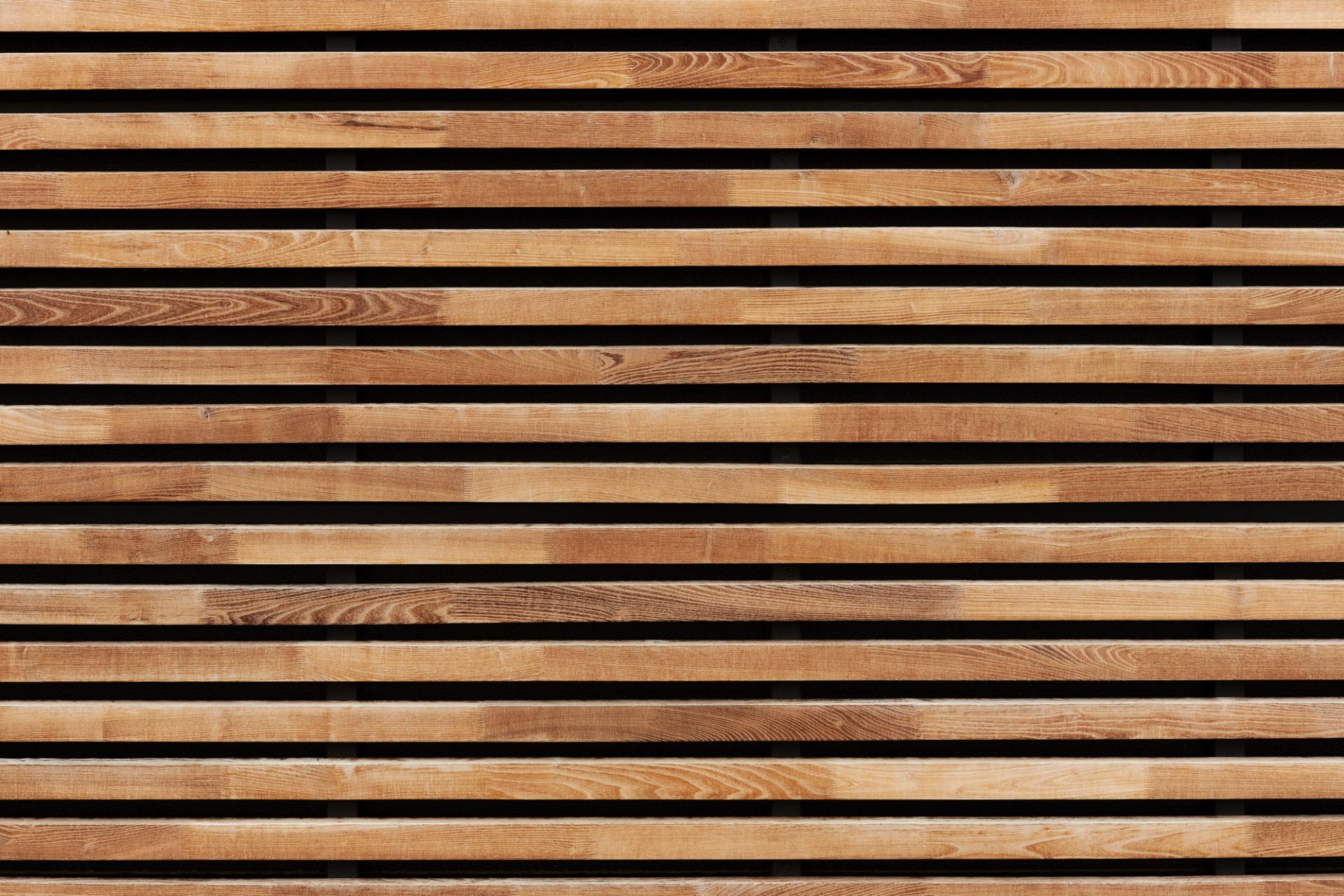 A close up of a wooden fence with black stripes — Overland Park, KS — Johnson County Solutions