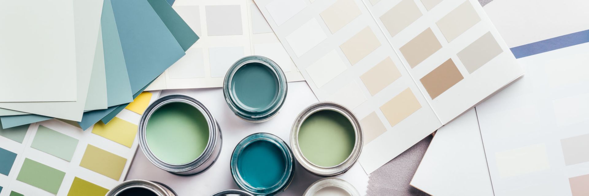 A bunch of paint cans and paint samples on a table — Overland Park, KS — Johnson County Solutions