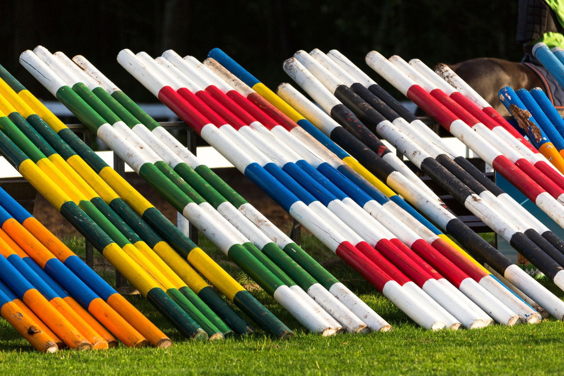 A bunch of colorful poles are stacked on top of each other in a field — Overland Park, KS — Johnson County Solutions