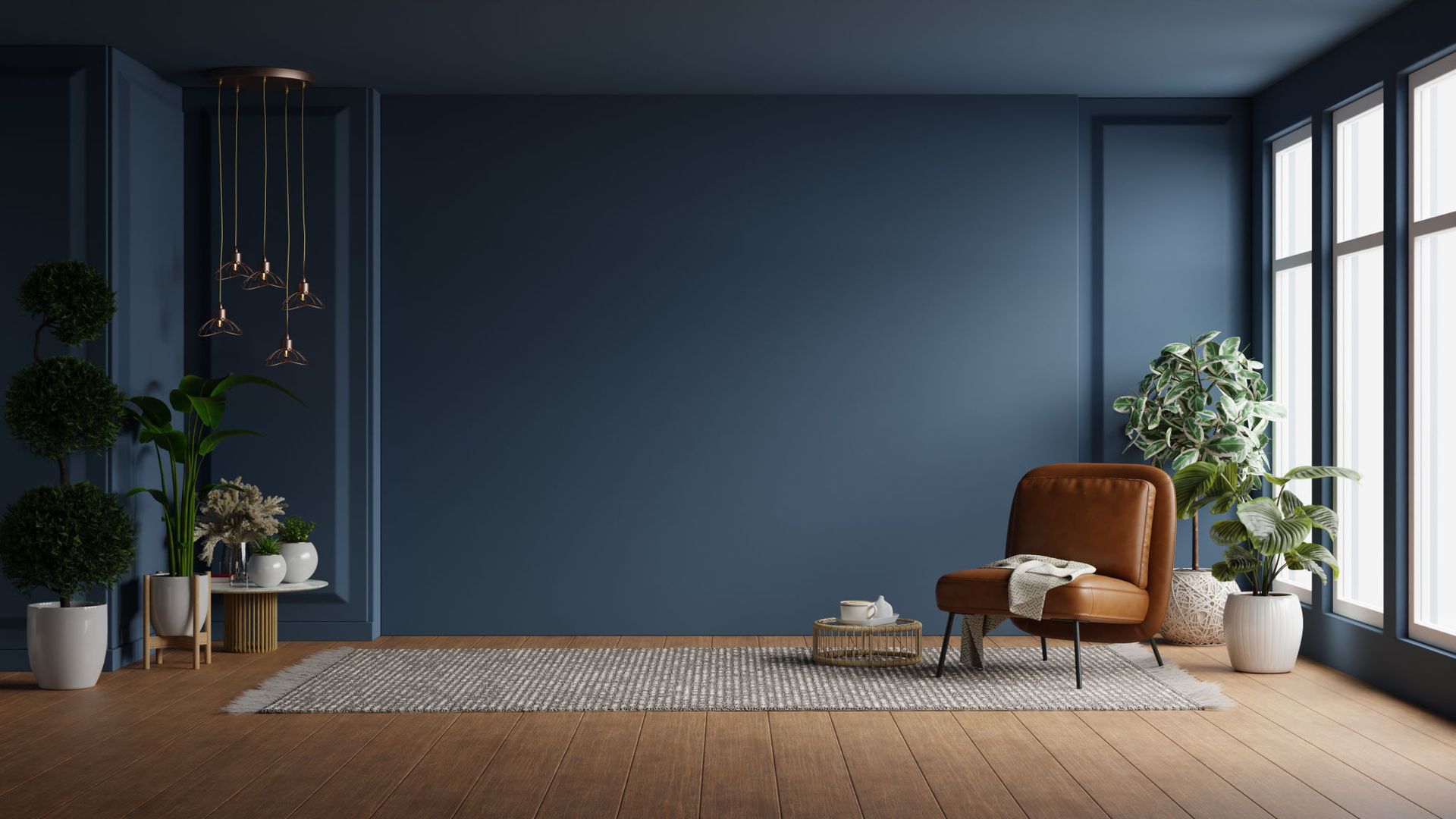 A living room with dark blue walls and a brown chair — Overland Park, KS — Johnson County Solutions