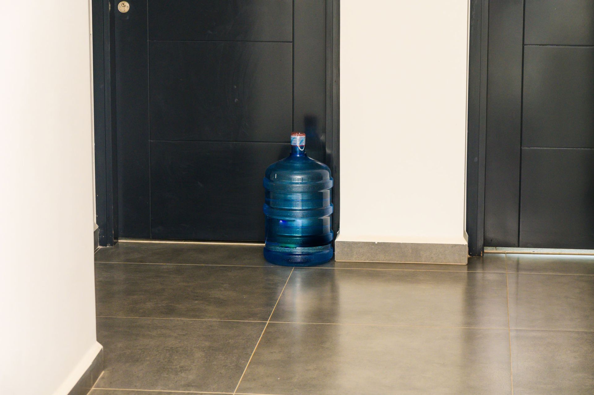 A bottle of water is sitting on the floor in a hallway — Overland Park, KS — Johnson County Solutions