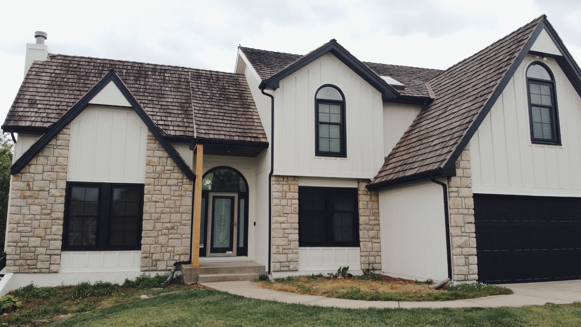 A white house with a brown roof and black windows — Overland Park, KS — Johnson County Solutions