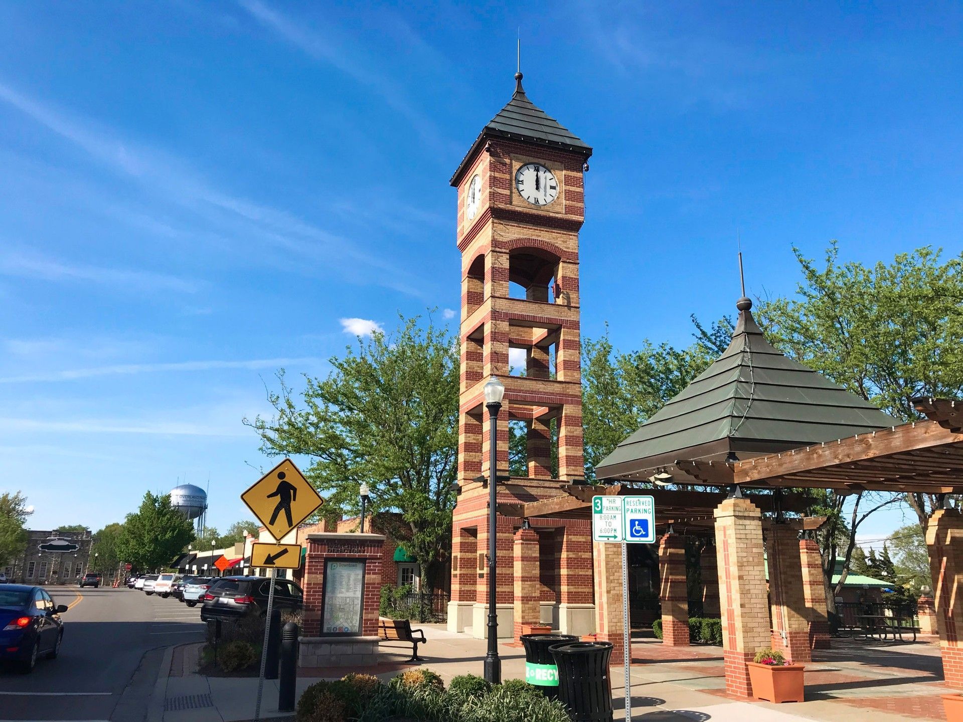 A brick clock tower with a clock on top of it — Overland Park, KS — Johnson County Solutions