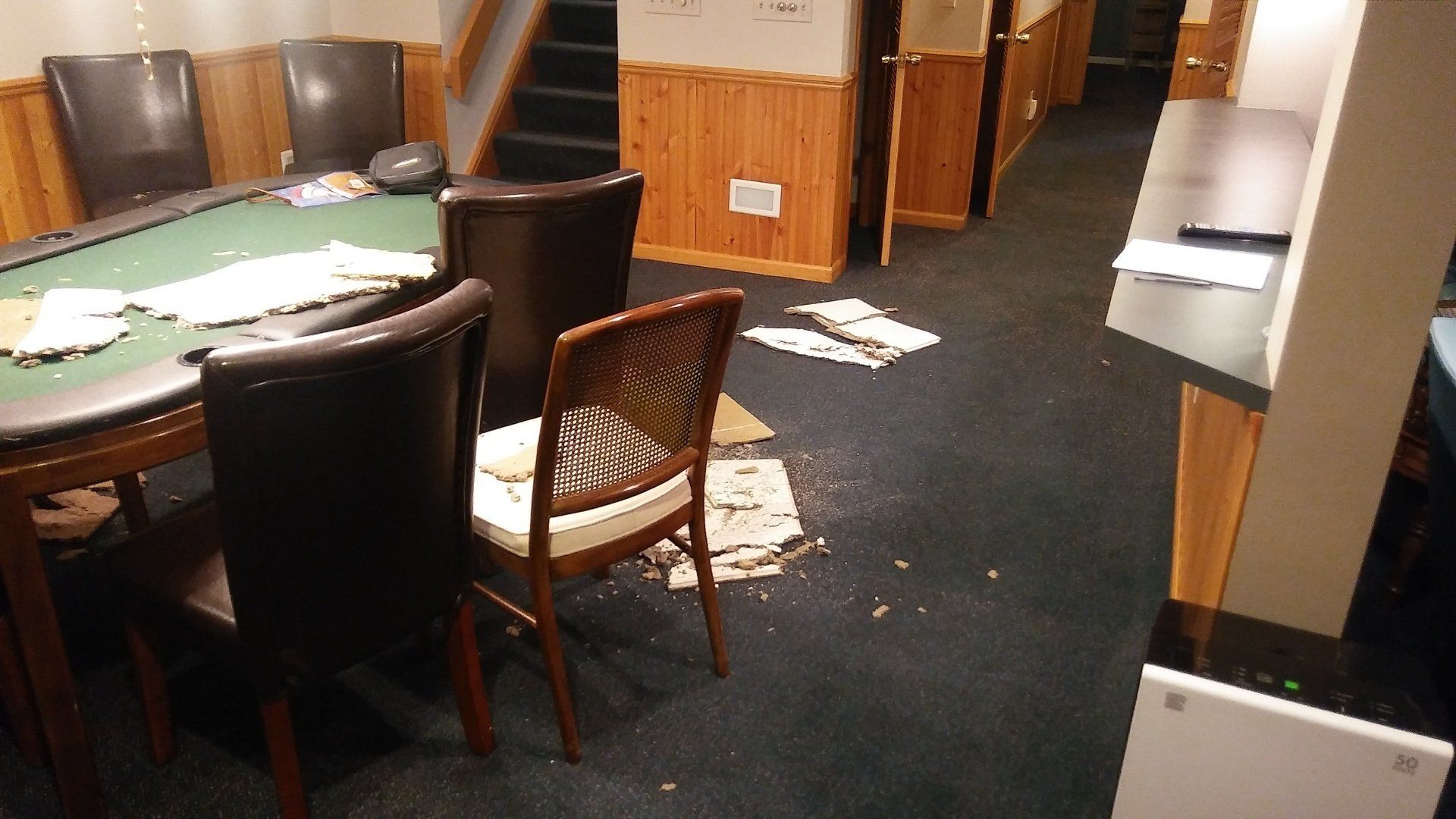 A room with a poker table and chairs in it