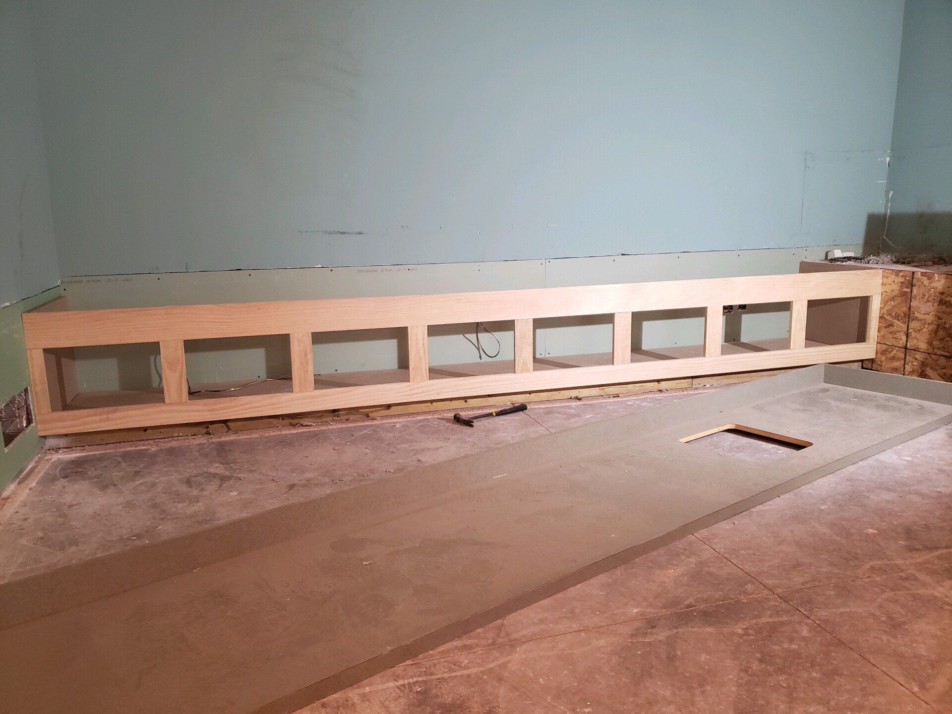 A large wooden box is sitting on the floor in a room.