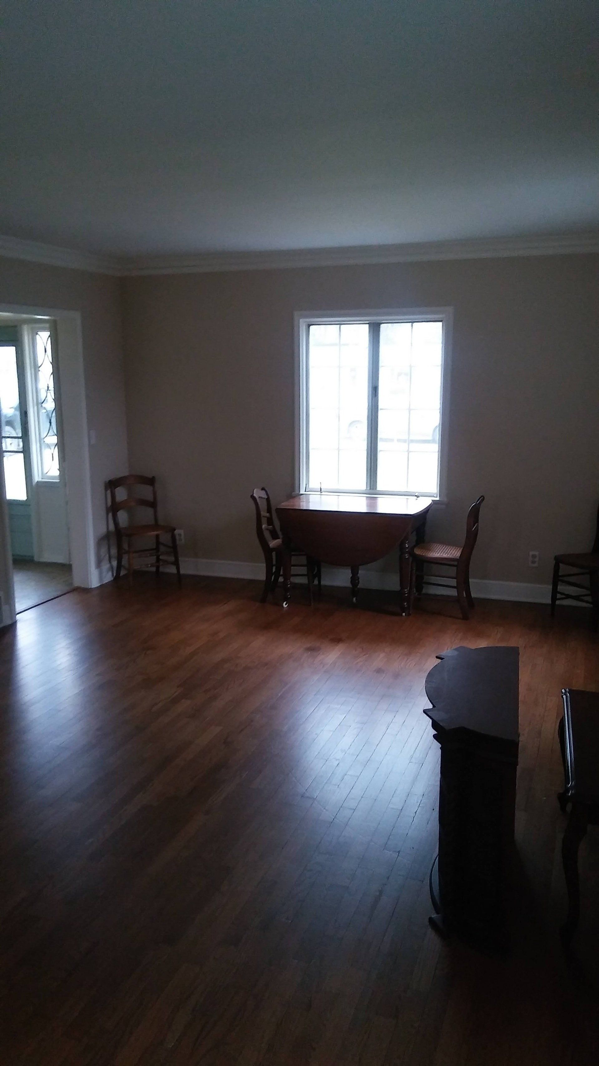 There is a table and chairs in the middle of the room.