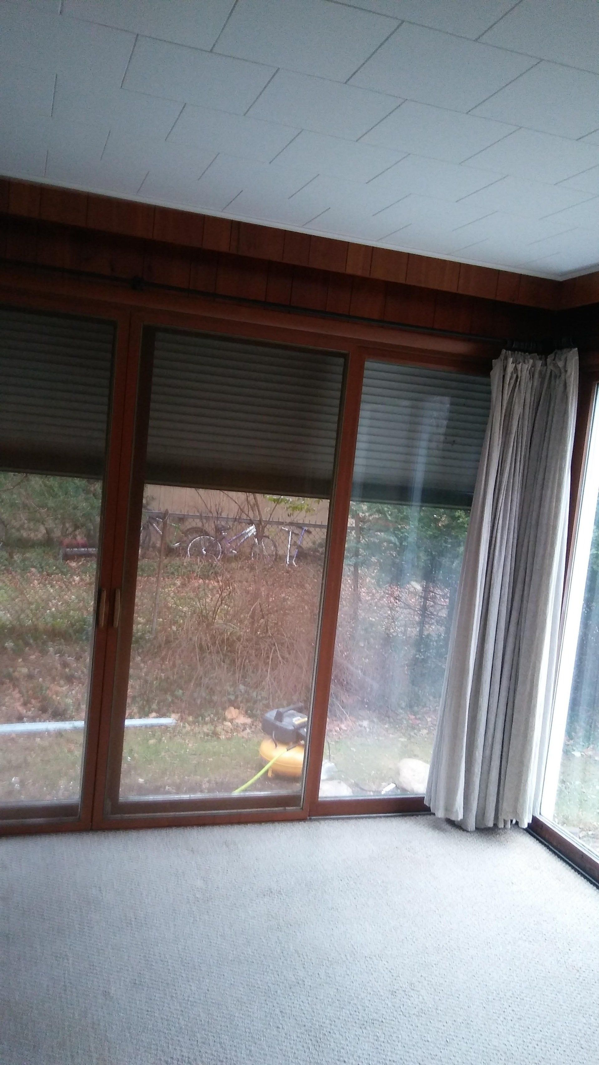 A room with a lot of windows and a carpeted floor.