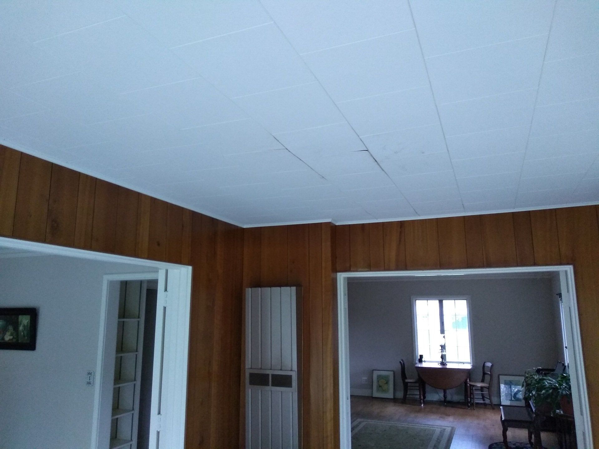 A room with wood paneling and a white ceiling