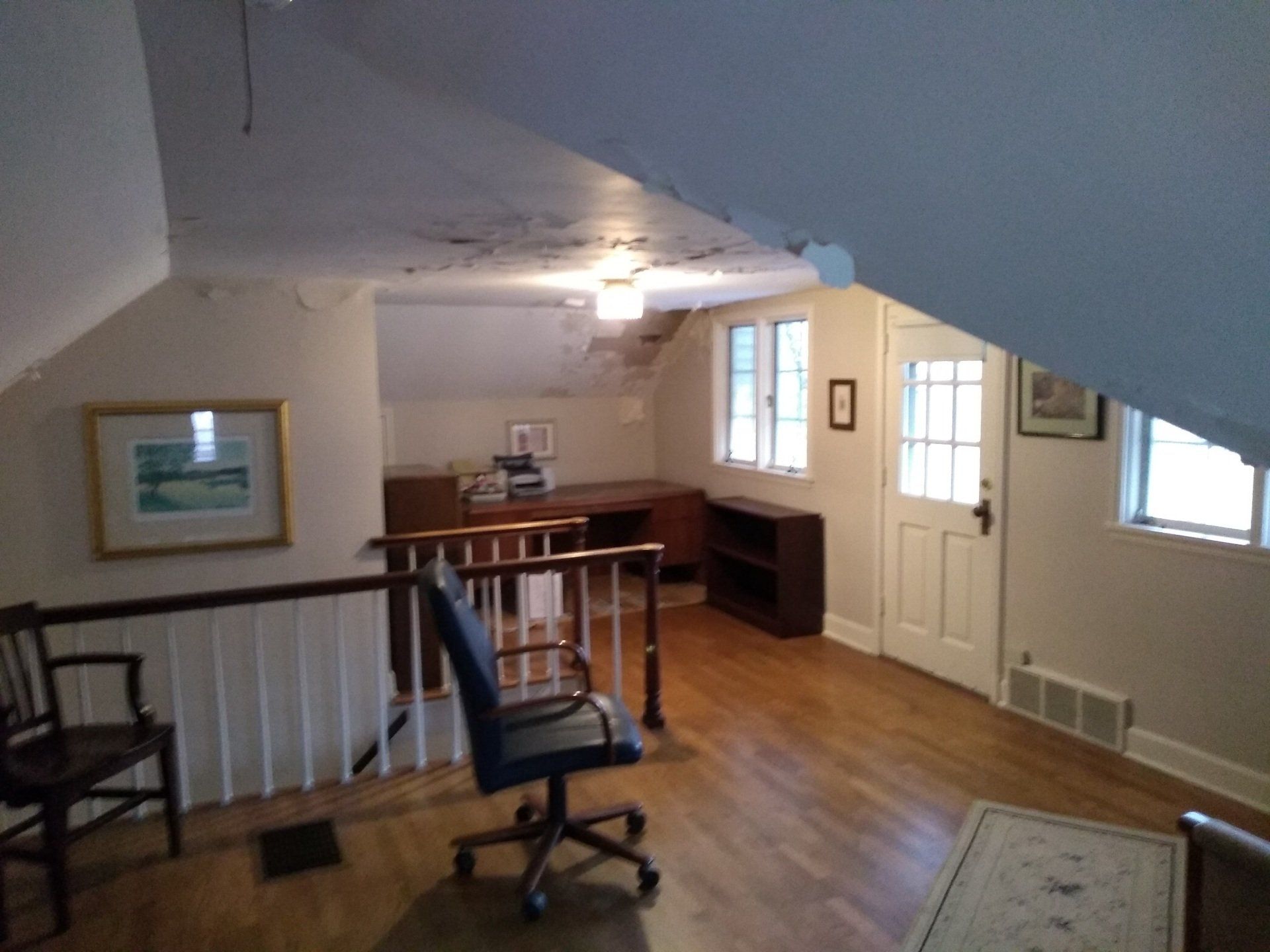 A room with a staircase and a chair in it