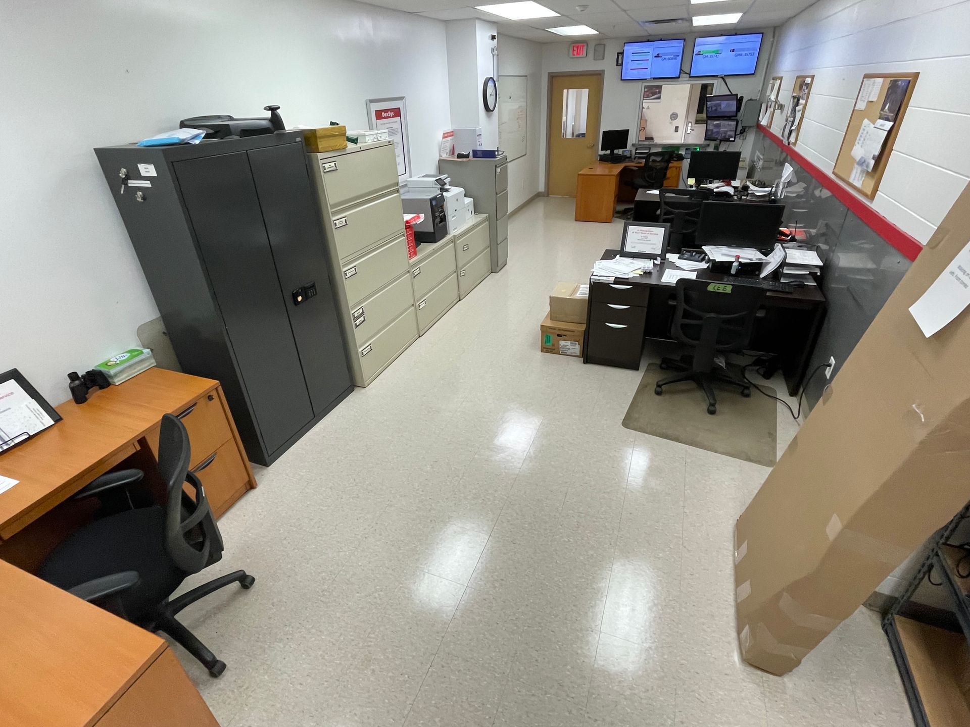 A large office with a lot of desks and cabinets.