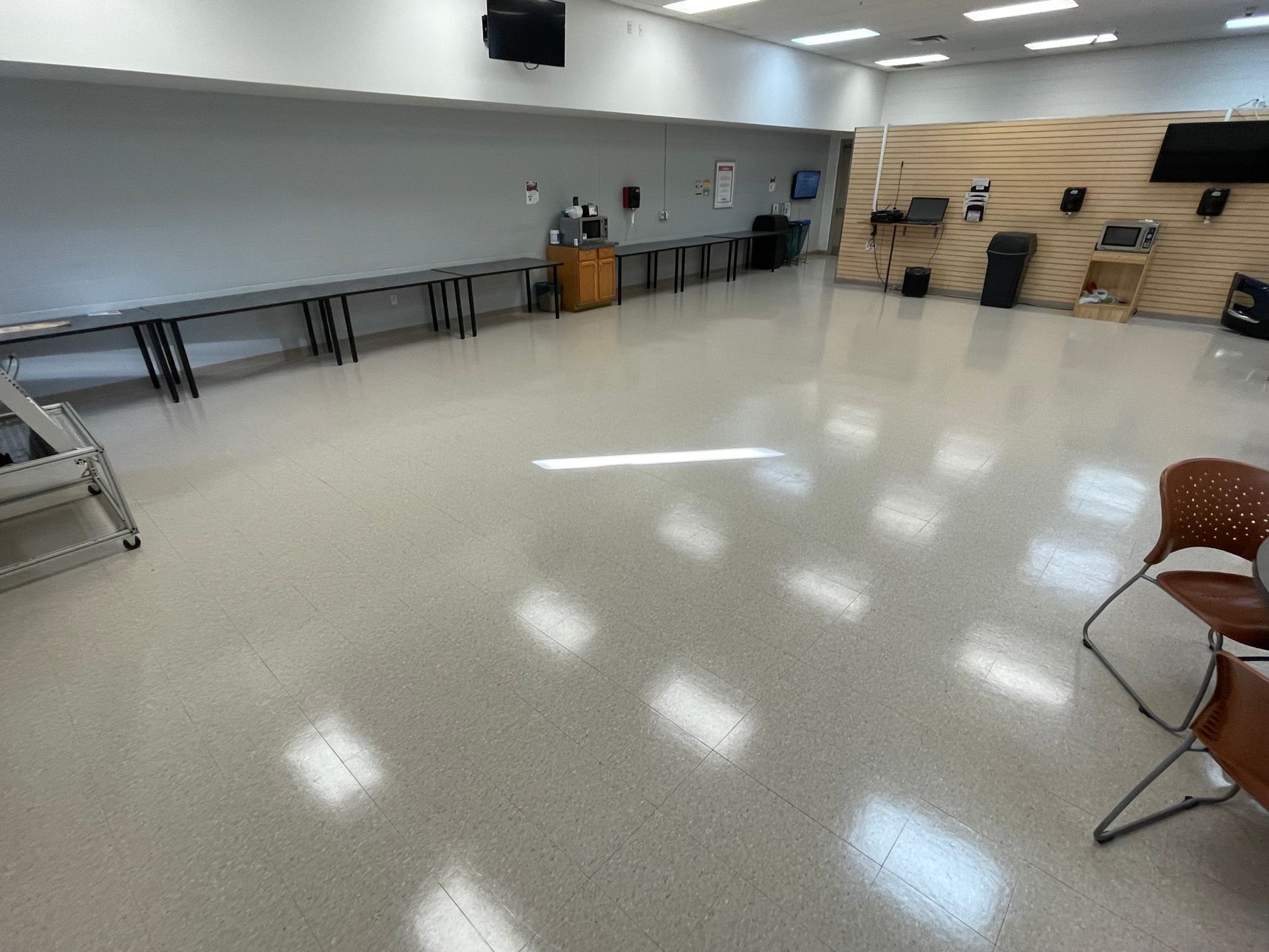 A large room with tables and chairs in it.