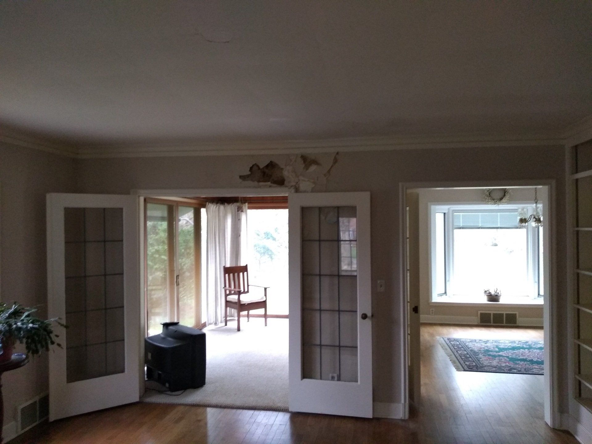 A living room with hardwood floors and sliding glass doors