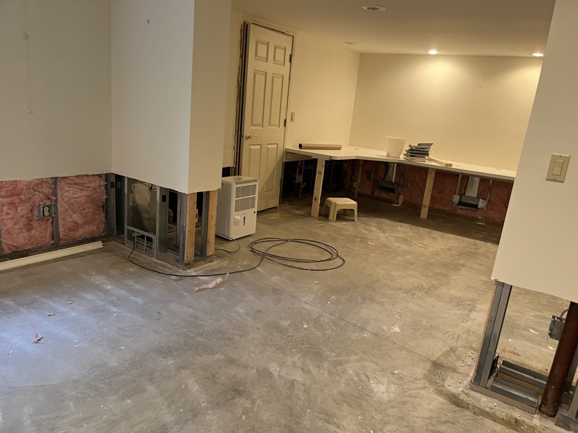 A basement is being remodeled and has a concrete floor.