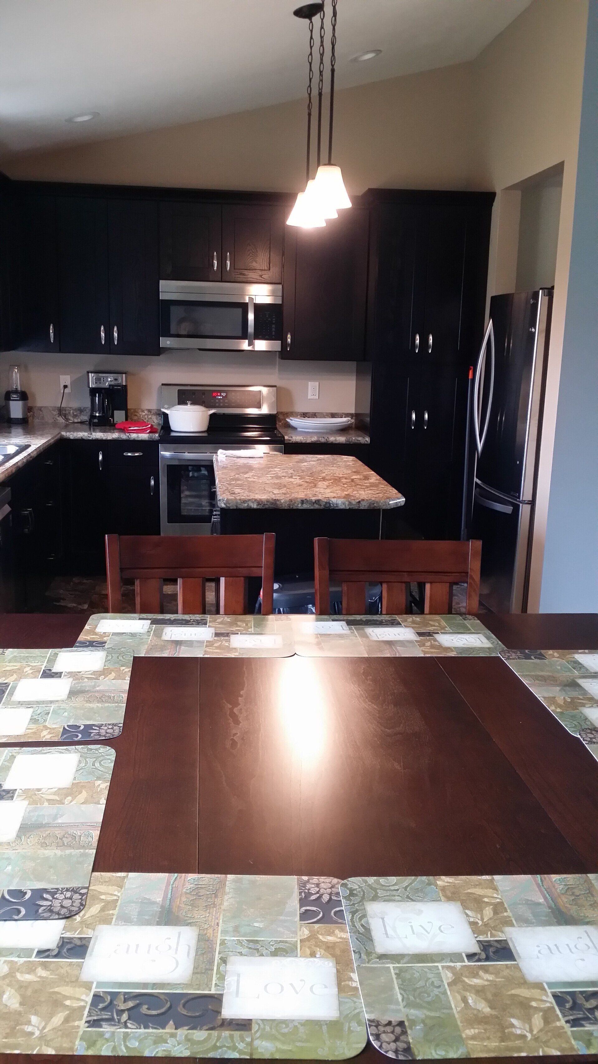 A kitchen with a table and chairs in it