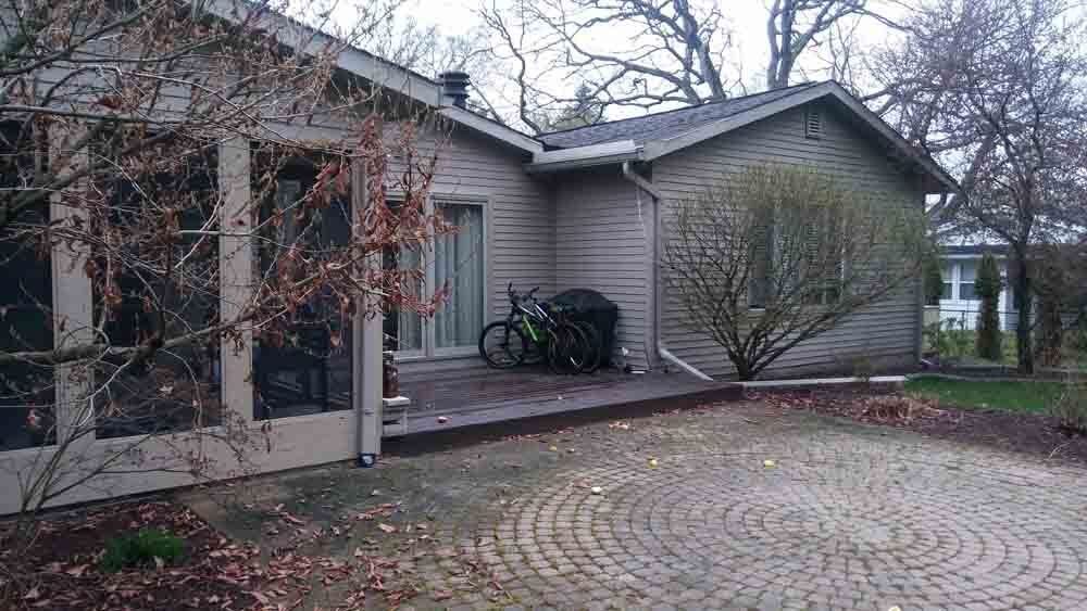 A house with a bicycle parked in front of it.
