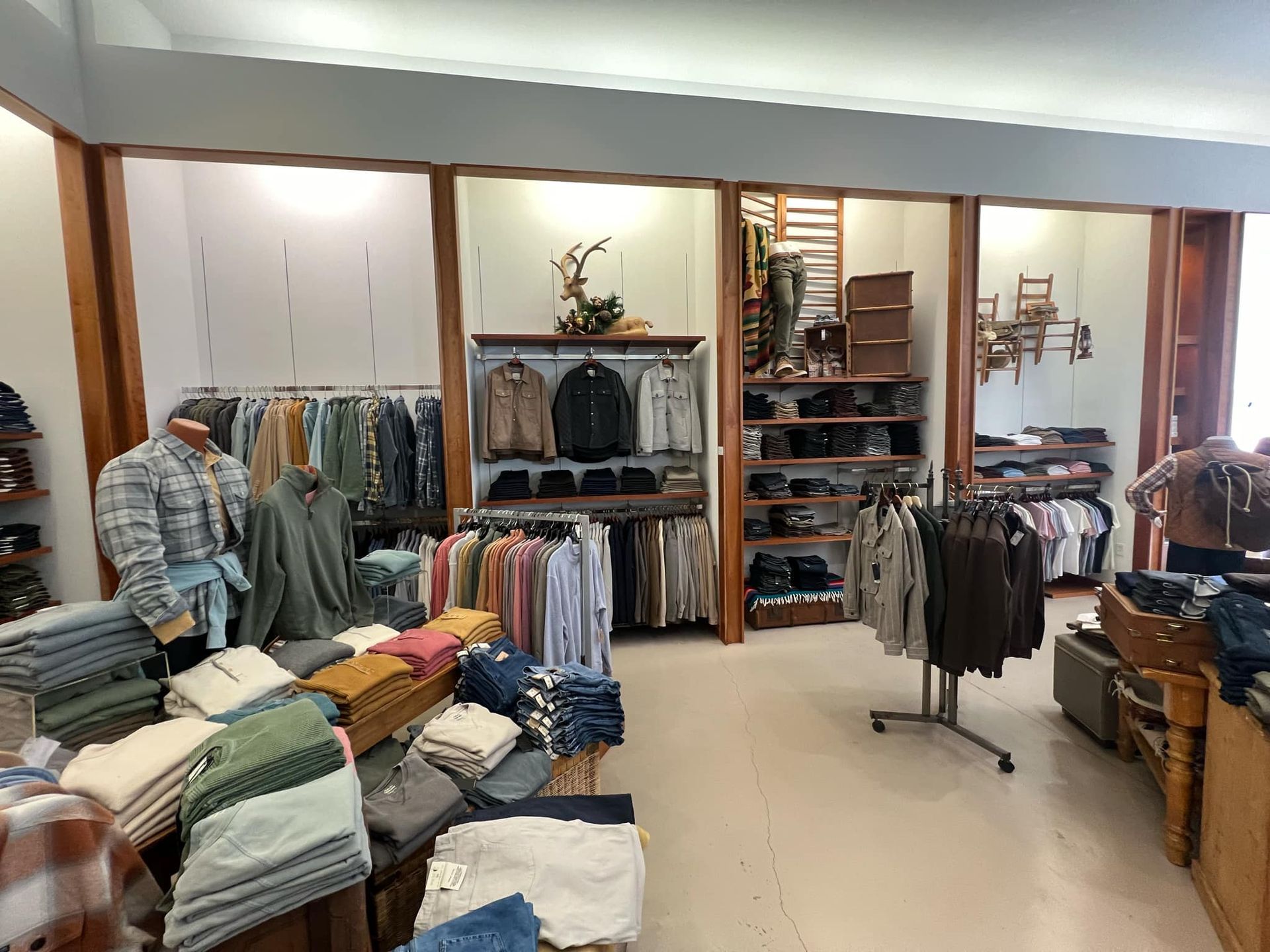 A clothing store with a lot of clothes on display.