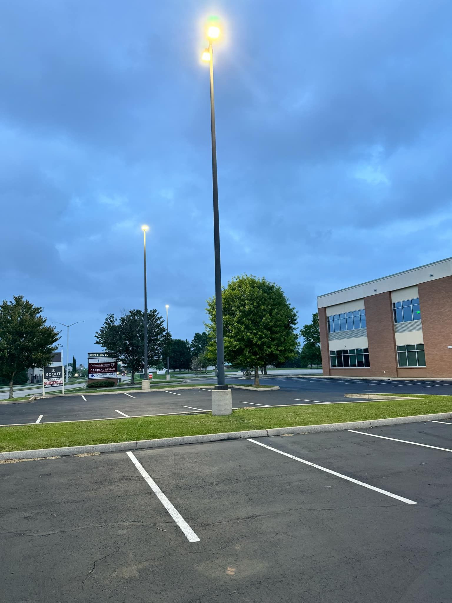 A parking lot with a brick building in the background