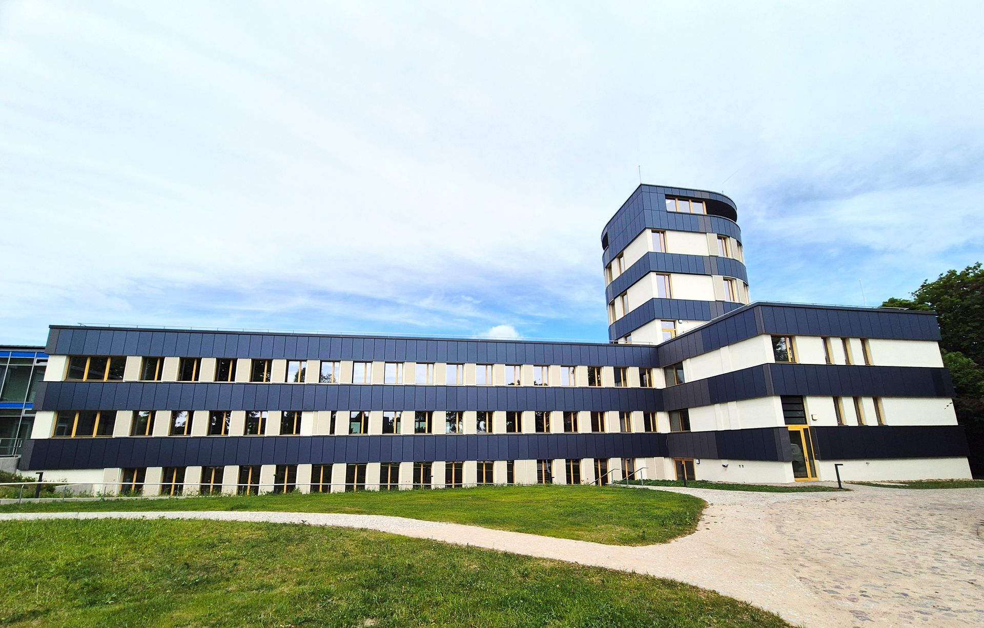 Ein großes schwarz-weißes Gebäude mit einem Turm darauf.