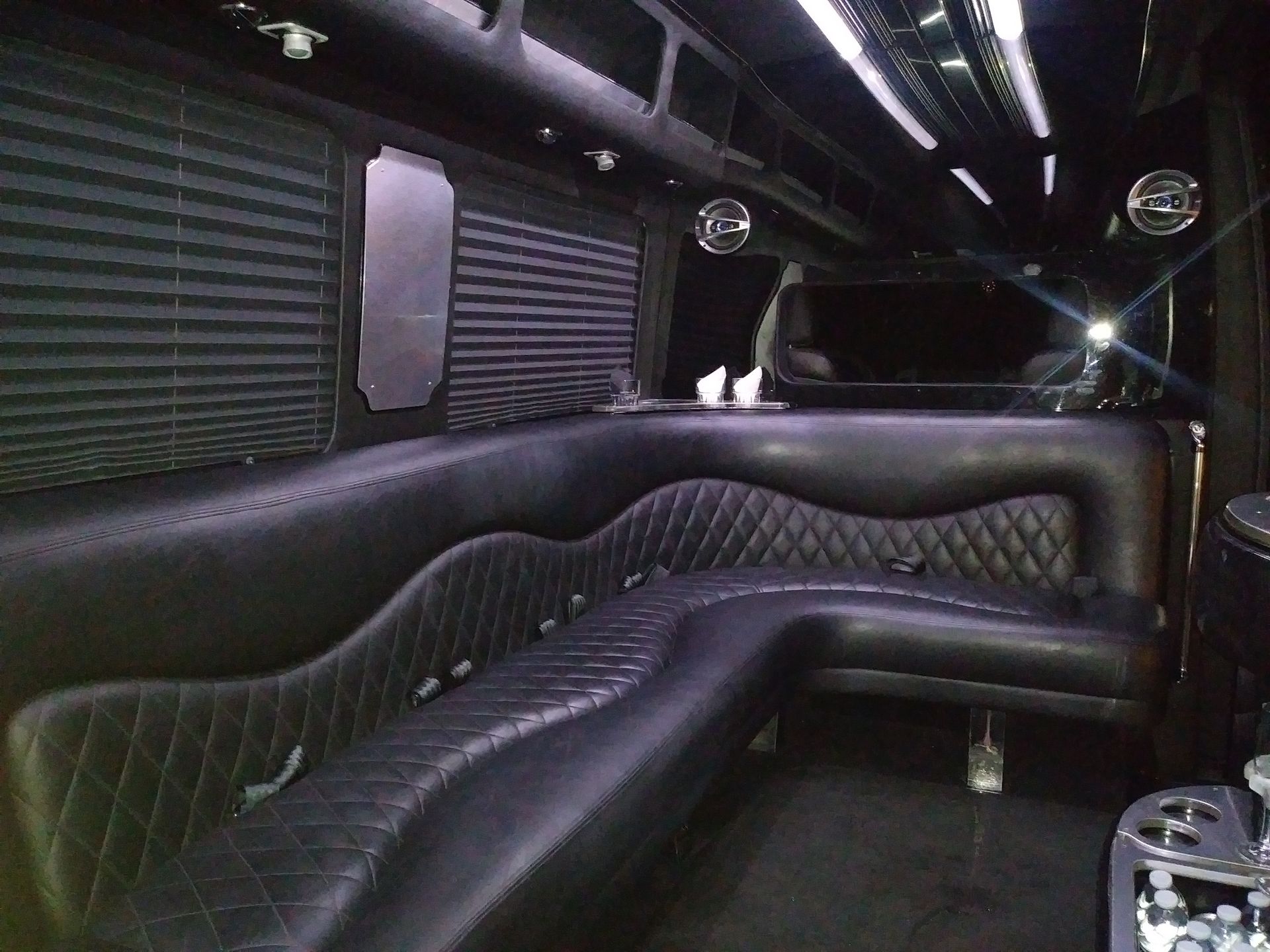 The inside of a limousine with black leather seats