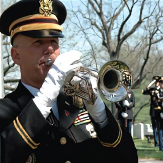 A man in a military uniform is playing a trumpet
