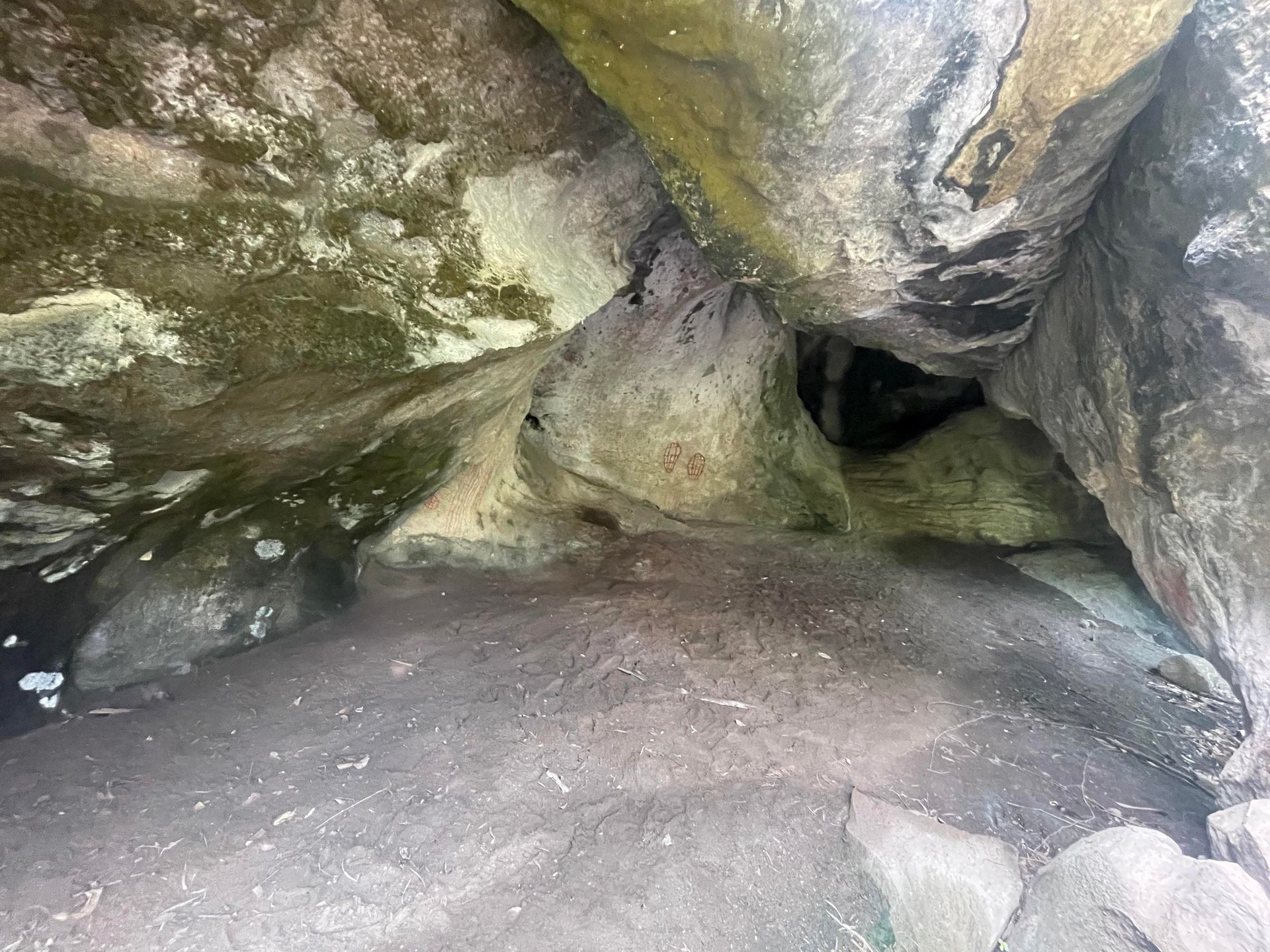 The inside of a cave filled with rocks and dirt.