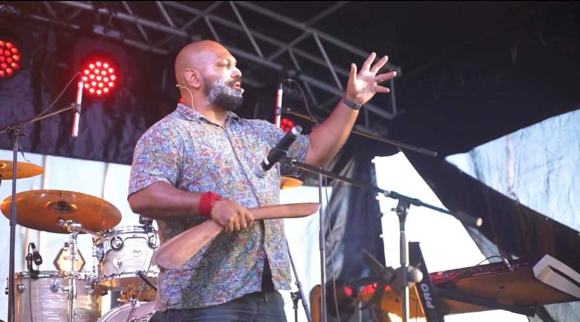 A man singing into a microphone on a stage