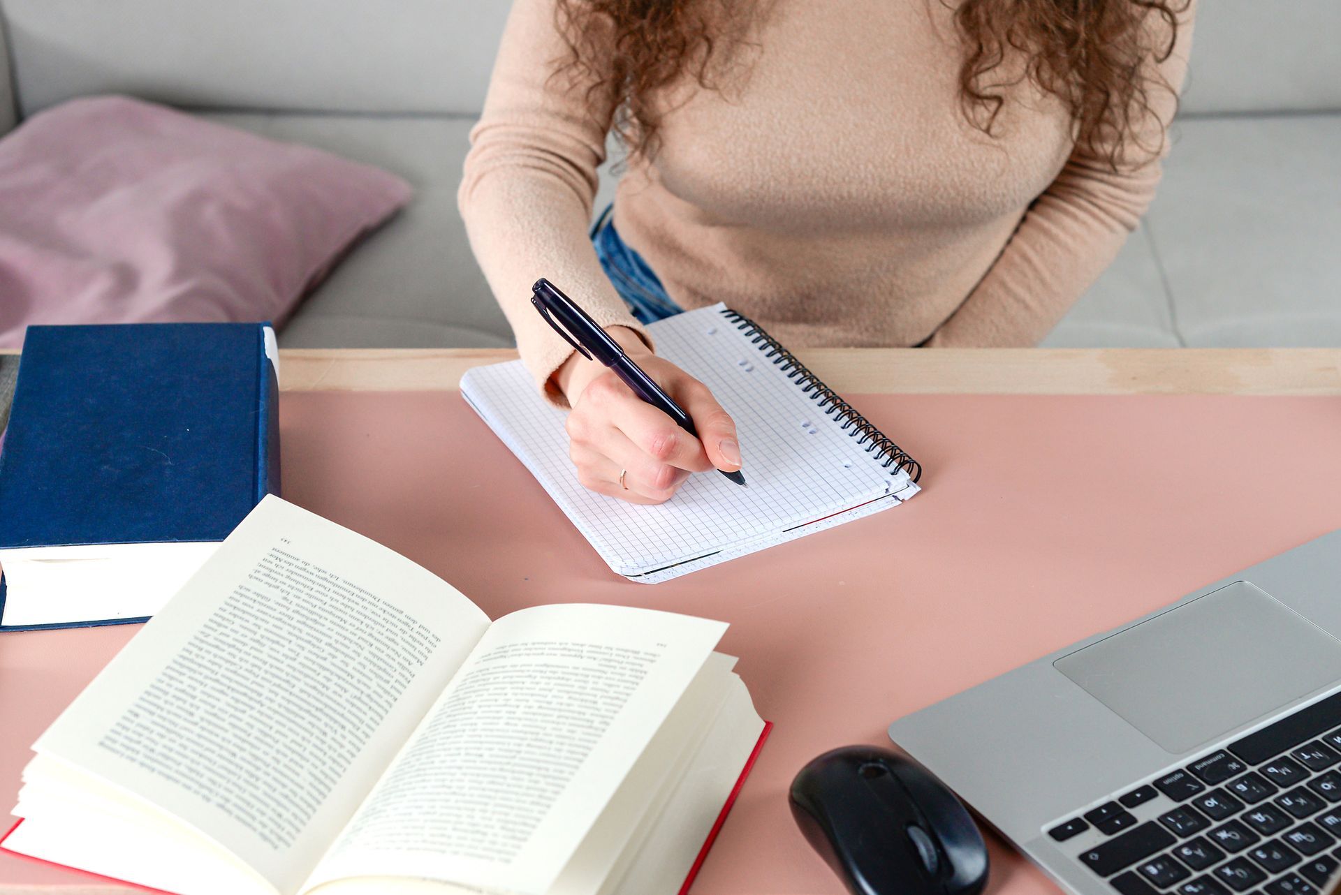individual who is focused diligently taking notes while studying. individual who is focused diligently taking notes while studying.
