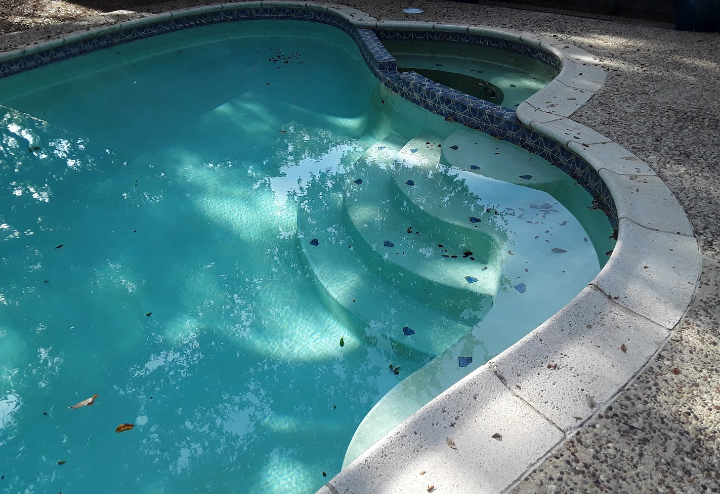 A swimming pool with stairs leading up to it