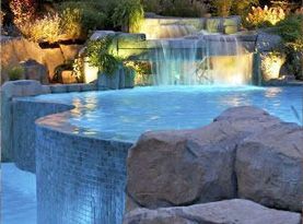 A swimming pool with a waterfall in the background