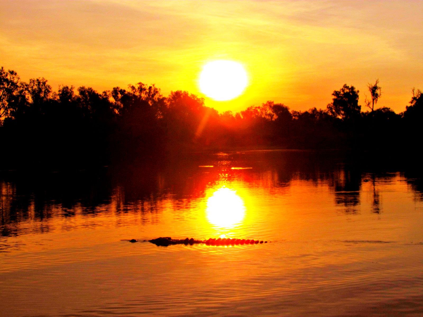 The sun is setting over a body of water