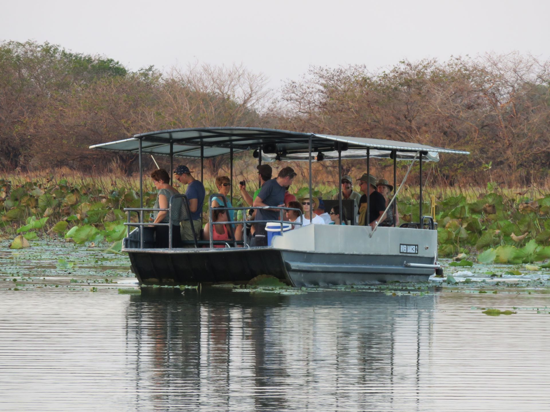 A group of people are riding a boat on a lake.