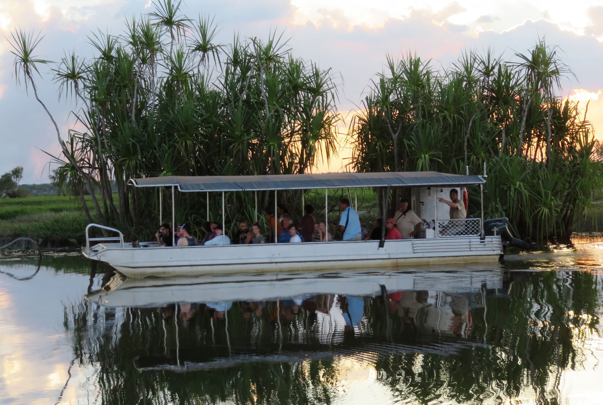 A boat with people on it is floating on a body of water