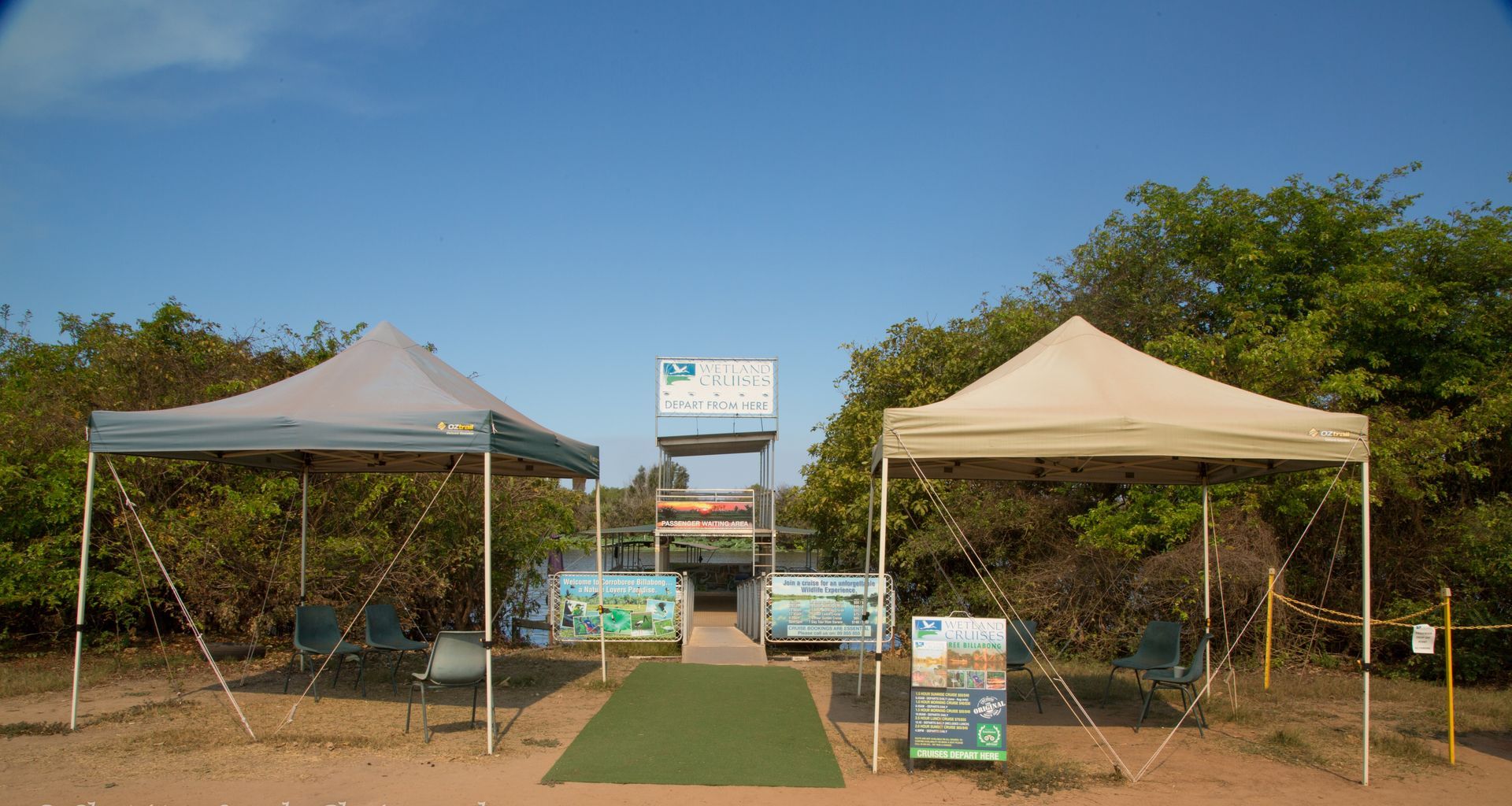 A group of tents are sitting on top of a dirt field.