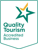 A quality tourism accredited business logo with a green star